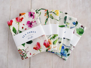 Green Botanical Tea Towel with Jean Choe's watercolor botanical artwork including tulips, eucalyptus, and other greenery