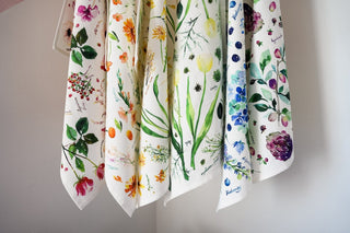 Green Botanical Tea Towel with Jean Choe's watercolor botanical artwork including tulips, eucalyptus, and other greenery
