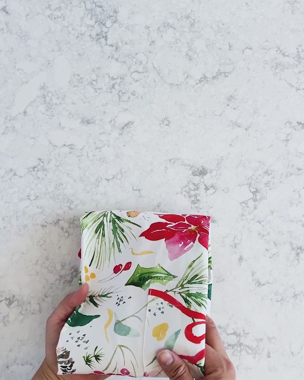 Video showing Jean Choe's cotton canvas apron with watercolor poinsettia and Christmas botanicals 