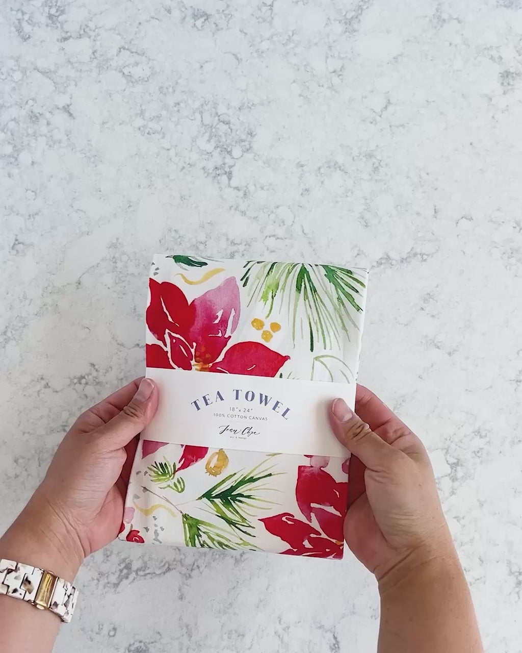 Video showing Jean Choe's cotton canvas tea towel with vibrant watercolor poinsettia for Christmas