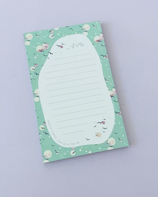 Product video showing notepad designed by Jean Choe where birds and dreamy bubbles are over the sky
