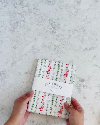 Video showing Jean Choe's cotton canvas tea towel with watercolor winter dainty sprigs