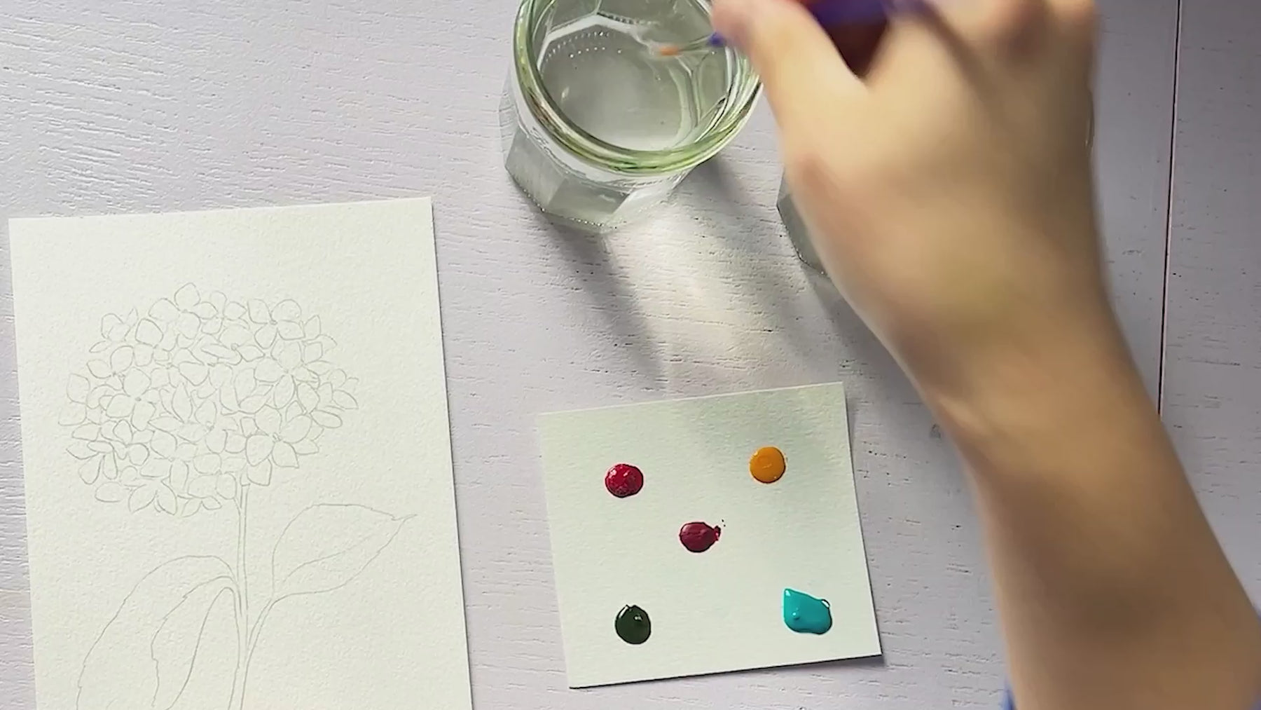 Video of painting watercolor hydrangeas and showing golden hour watercolor painting against sunrise