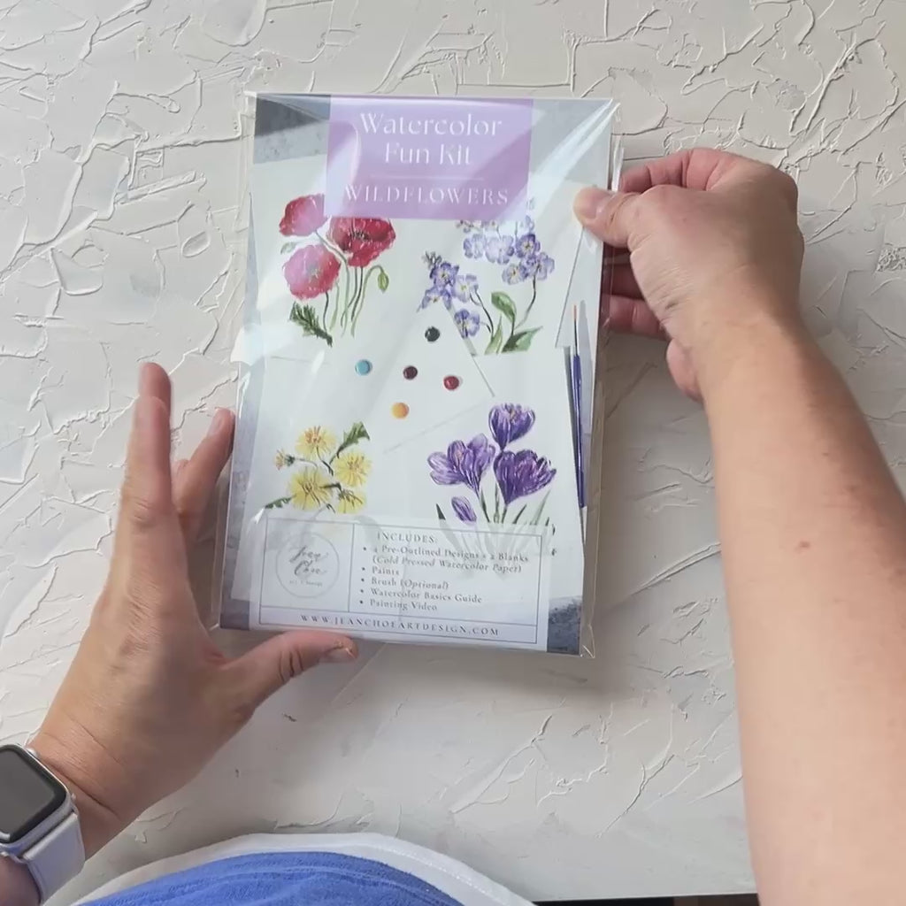 Video showing Jean Choe's watercolor fun kit for Wildflowers, with pre-outlined pages, a paint dot card and a brush.