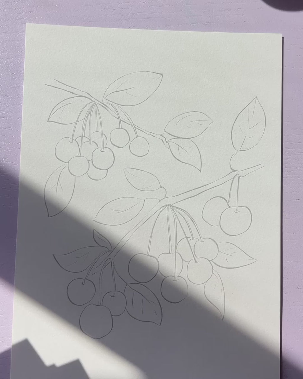 Video showing Jean Choe's watercolor pages with pre-outlined designs of  fruits
