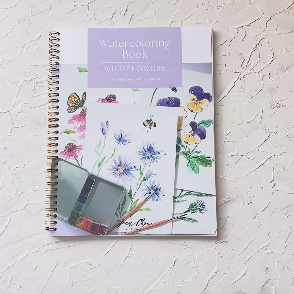 Video showing Jean Choe's watercolor workbook for Wildflowers, with pre-outlined pages, and step by step instructions.