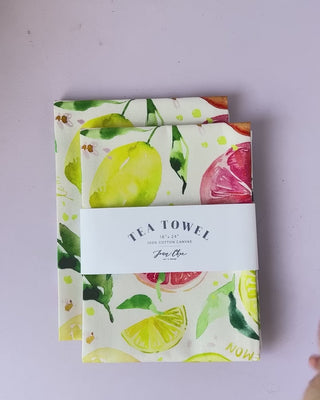 Video showing Jean Choe's cotton canvas tea towel with vibrant watercolor citrus