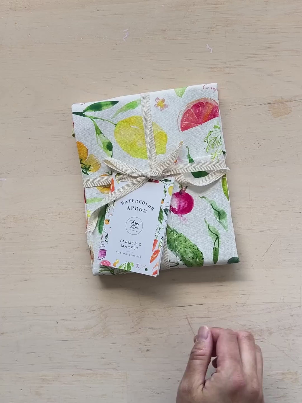 Video showing Jean Choe's cotton canvas apron with watercolor fruits and vegetables