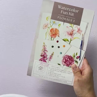 Video showing Jean Choe's watercolor fun kit for Florals of poppy, lily, foxglove and rose, with pre-outlined pages, a paint dot card and a brush.