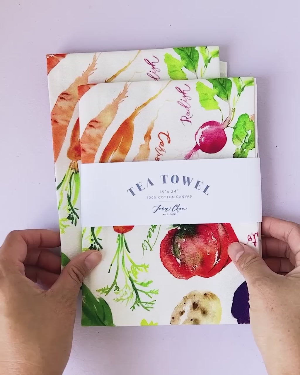 Video showing Jean Choe's cotton canvas tea towel with vibrant watercolor vegetables