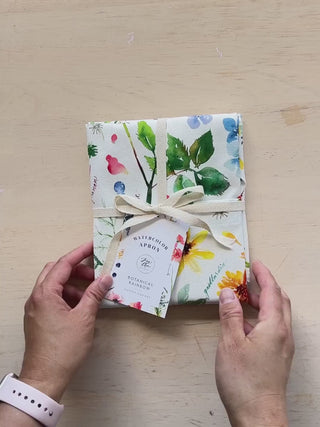 Video showing Jean Choe's cotton canvas apron with watercolor florals and botanicals